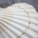 Ball and chain short necklace in yellow gold 
